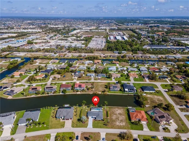 Aerial overview of property's location featuring nearby suburban area and a nearby body of water