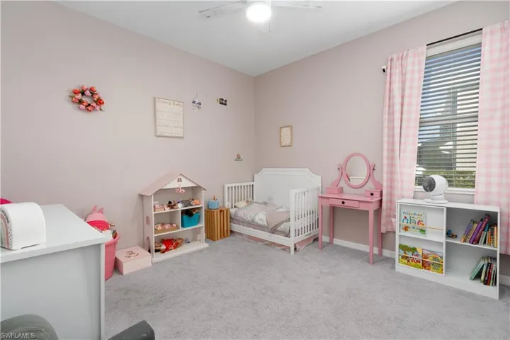 Rec room featuring ceiling fan and light colored carpet