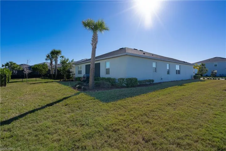 View of home's exterior featuring a large side and back yard with room for a pool