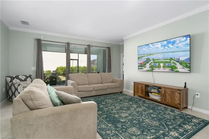 Tiled living room featuring ornamental molding