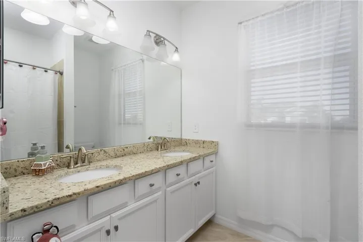 Bathroom with vanity, tile patterned flooring, and shower / bath combo