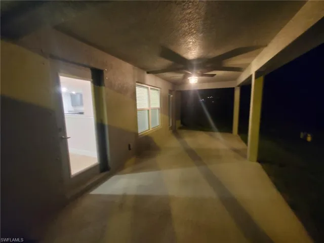 Corridor featuring concrete flooring and a textured ceiling