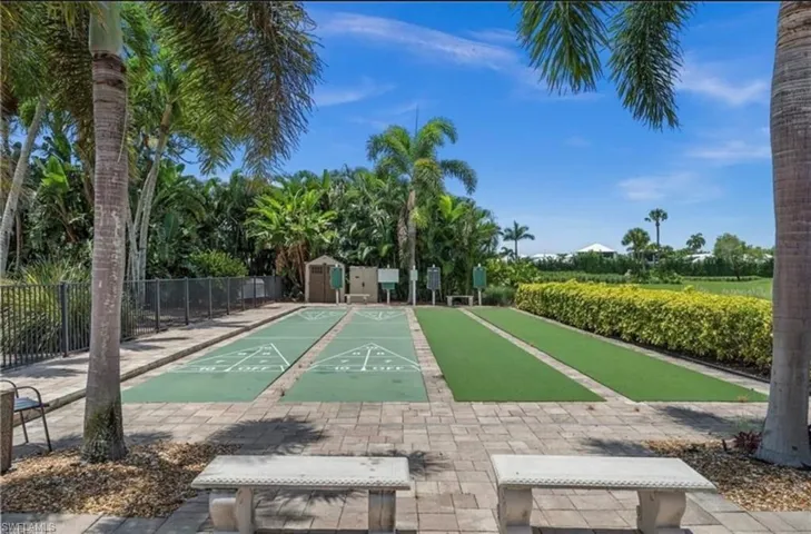 View of home's community with shuffleboard and a storage shed