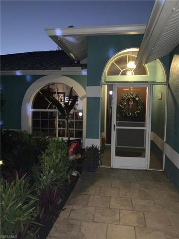 Lighted entry lined w/gardens