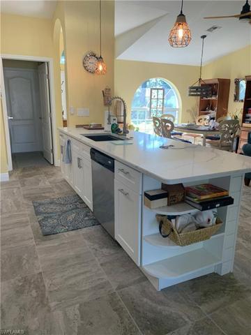 Built-in book shelf, spice cabinet, & trash/recycle