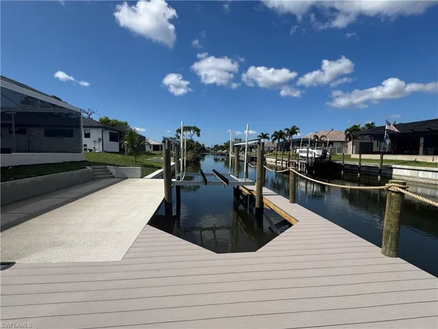 View of dock featuring a water view and a lanai