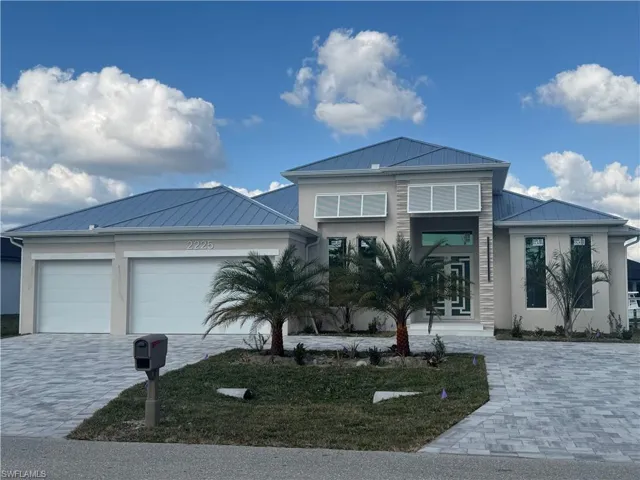 View of front of house featuring a garage and french doors