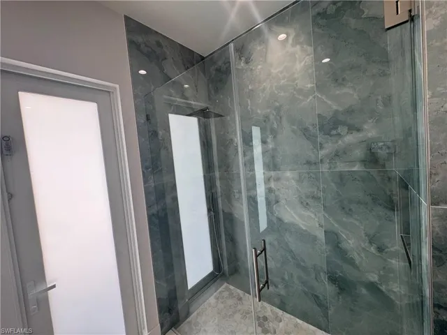 Bathroom with a shower with shower door