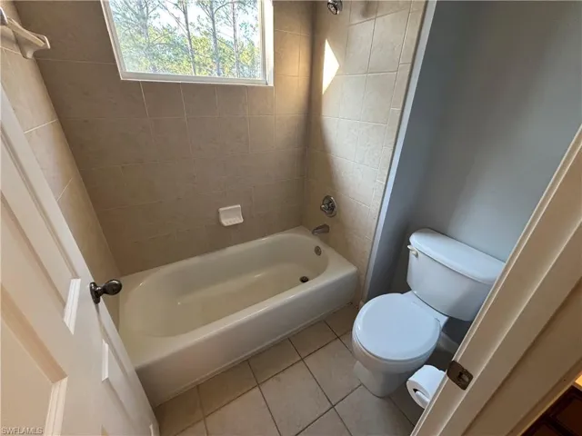 Full bathroom featuring tile patterned flooring and bathing tub / shower combination