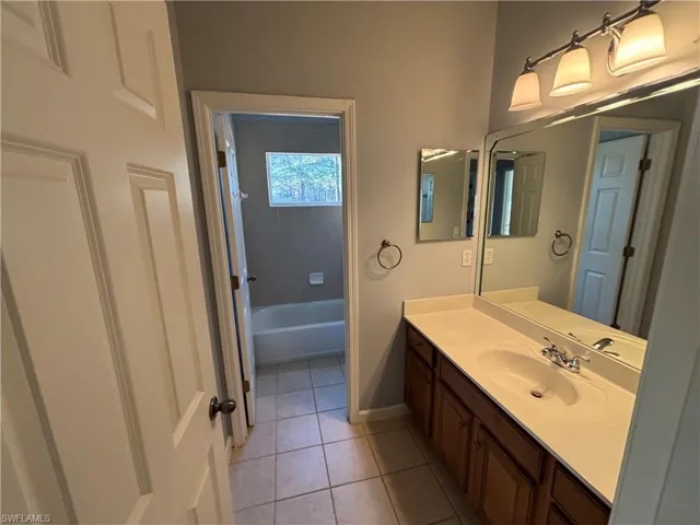 Bathroom with vanity and light tile patterned floors