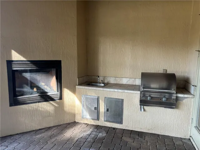 View of patio / terrace featuring an outdoor kitchen and a sink