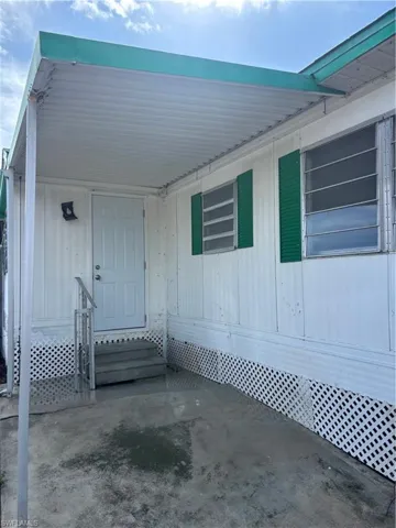 View of exterior entry featuring a patio