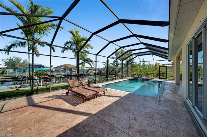 Pool with a patio area and a lanai