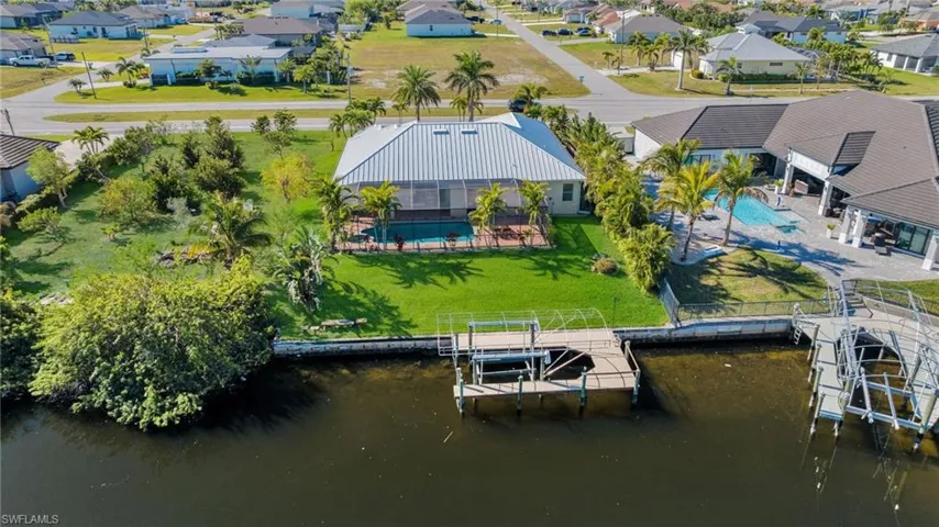 Drone / aerial view with a residential view and a water view