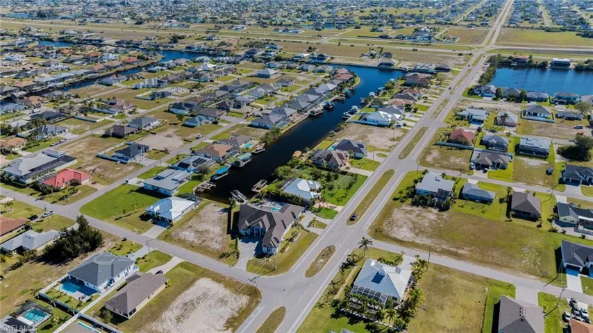 Birds eye view of property featuring a residential view and a water view