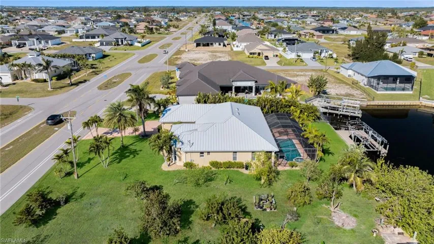 Birds eye view of property with a residential view and a water view