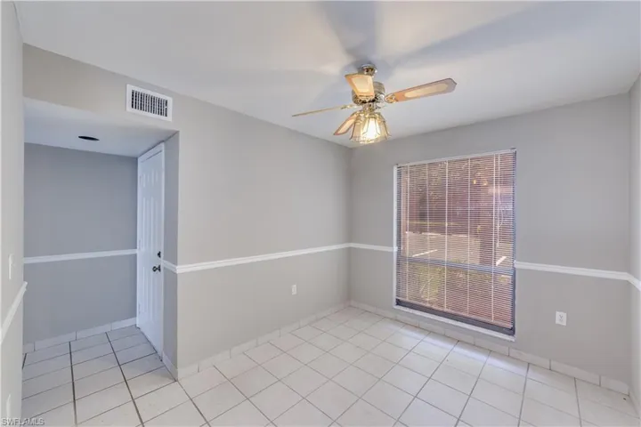 Tiled empty room with ceiling fan