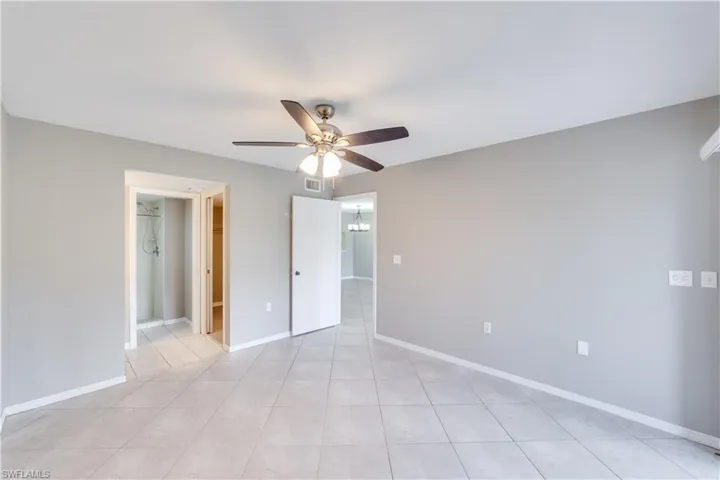 Tiled empty room featuring ceiling fan