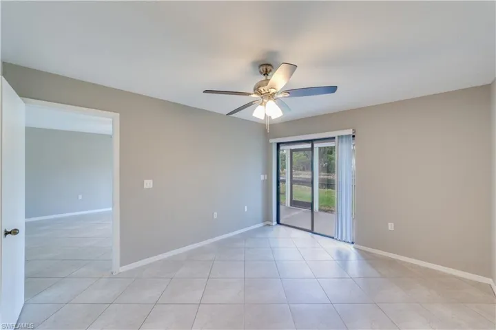 Tiled empty room featuring ceiling fan