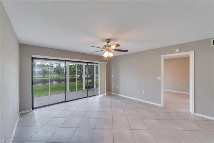 Empty room featuring ceiling fan and light tile flooring