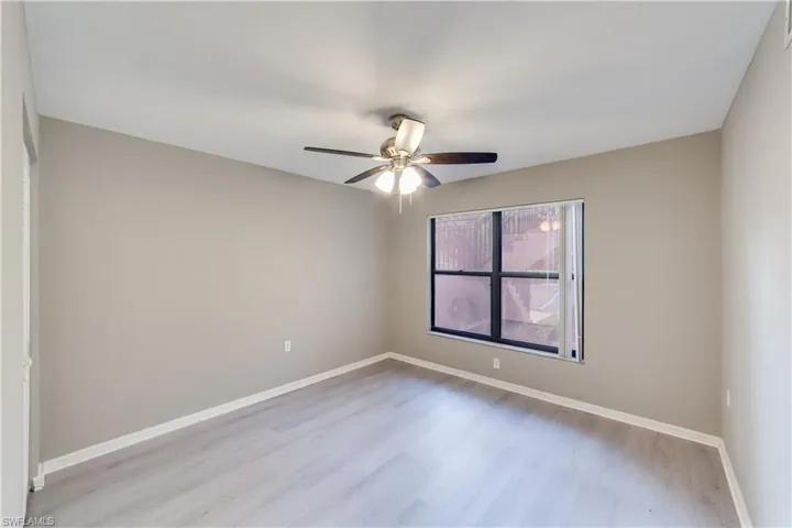 Unfurnished room featuring ceiling fan and light wood-type flooring
