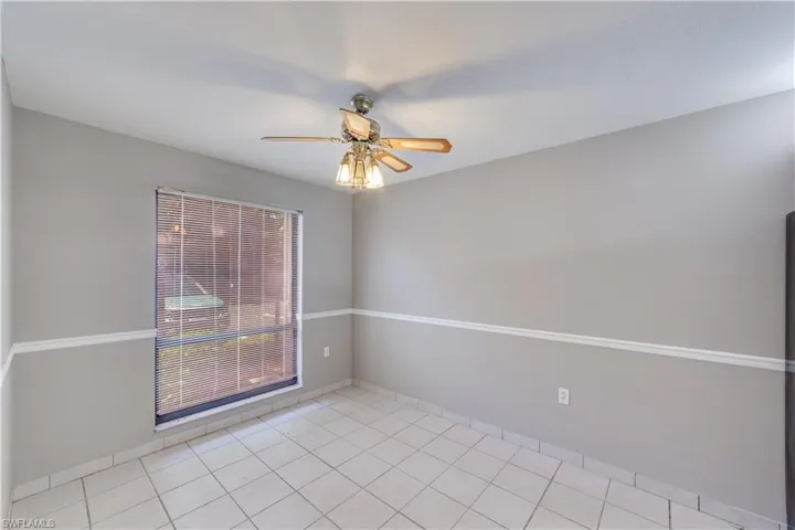 Unfurnished room featuring ceiling fan and light tile floors