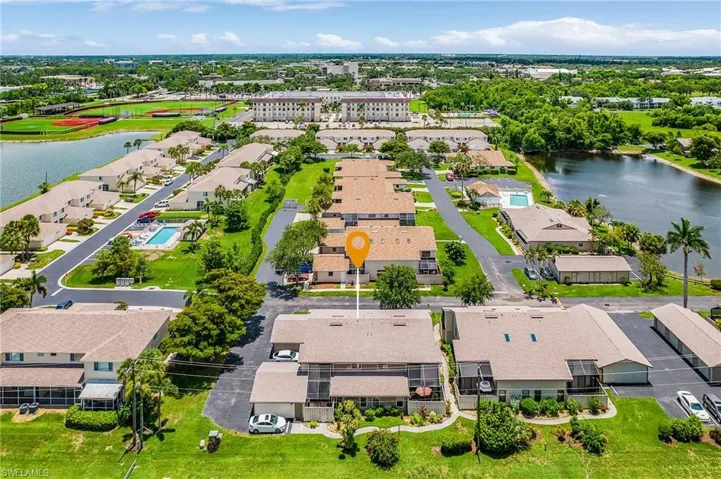 Aerial perspective of suburban area featuring a large body of water