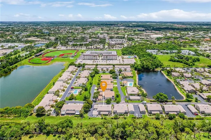 Aerial perspective of suburban area with a nearby body of water