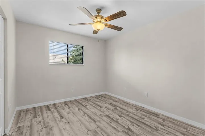 Empty room featuring light wood-type flooring and ceiling fan