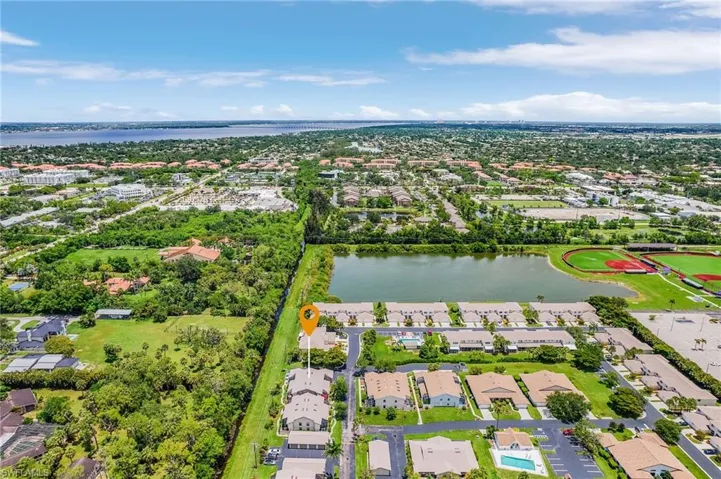 Aerial view of residential area featuring a nearby body of water