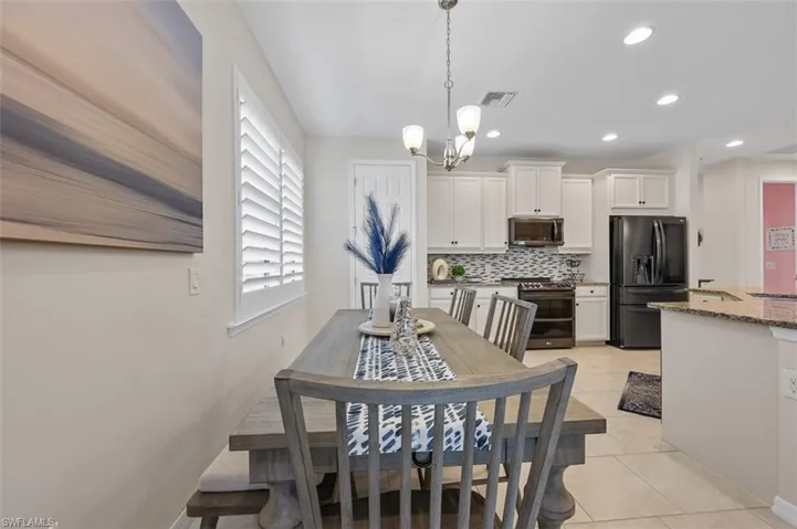 Dining room featuring visible vents, a chandelier, recessed lighting, and light tile patterned floors
