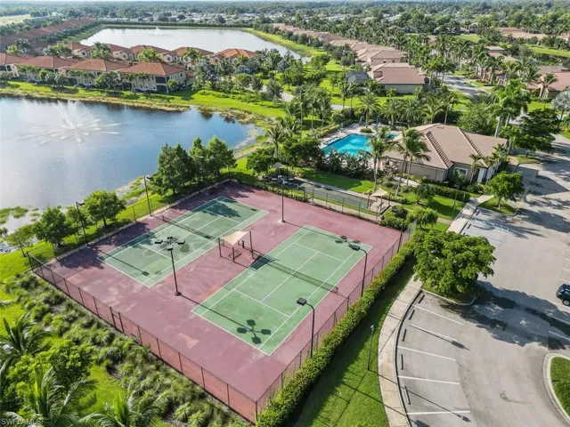 Birds eye view of property featuring a water view and a residential view