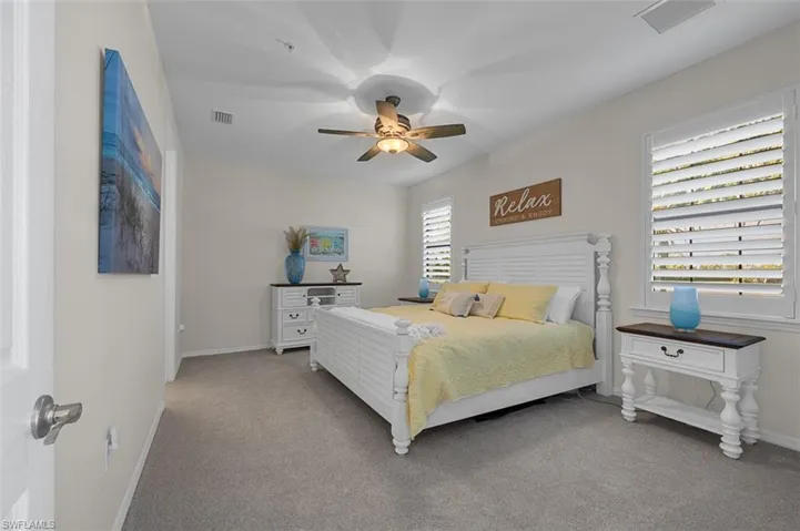 Bedroom with baseboards, carpet floors, and visible vents