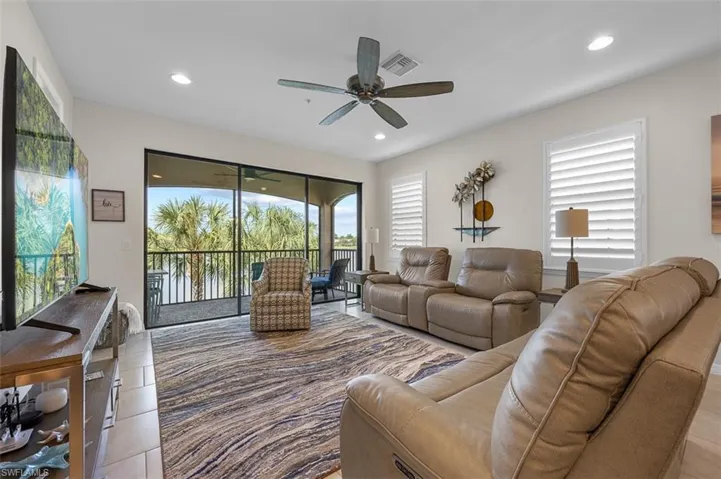Living area with light tile patterned flooring, recessed lighting, and a ceiling fan