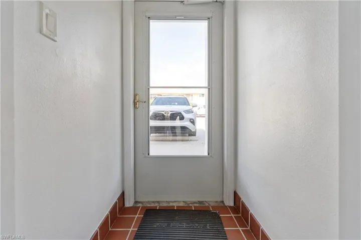 Doorway featuring a textured wall