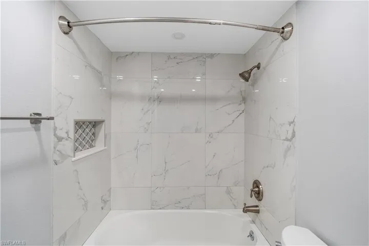 Full bathroom featuring bathing tub / shower combination and toilet