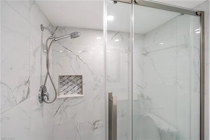 Bathroom featuring a marble finish shower