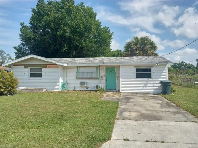Single story home featuring a front lawn