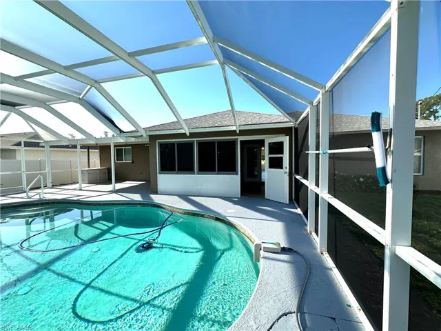 View of pool with a fenced in pool, a patio area, and a lanai
