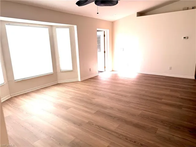 Spare room with wood finished floors and ceiling fan