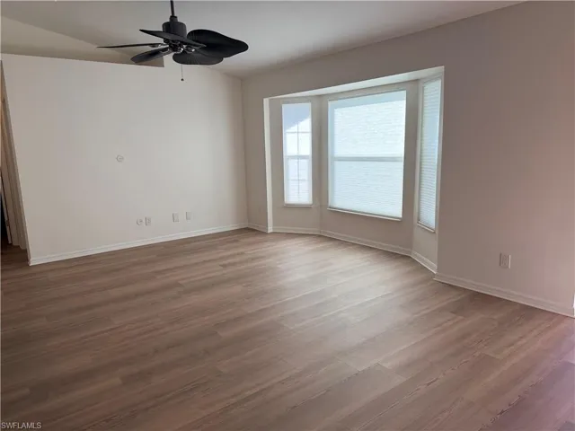 Unfurnished room with light wood-style floors and a ceiling fan