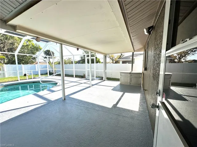View of pool with a fenced backyard, an outdoor structure, a patio, a lanai, and a fenced in pool