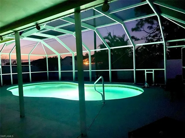 Outdoor pool with a lanai and a patio area