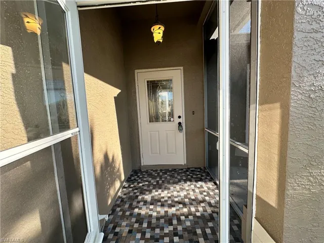View of exterior entry featuring stucco siding
