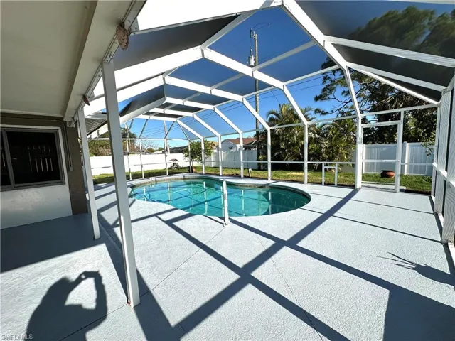 View of pool featuring a patio area, a fenced backyard, a fenced in pool, and a lanai