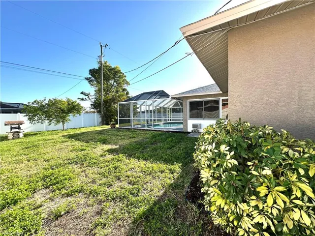 View of yard with a fenced backyard, a fenced in pool, and a lanai