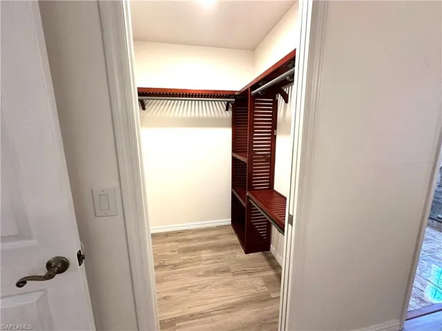 Walk in closet featuring light wood-style flooring