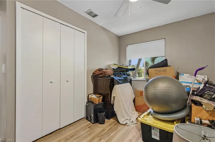 Home office featuring ceiling fan and light wood-type flooring