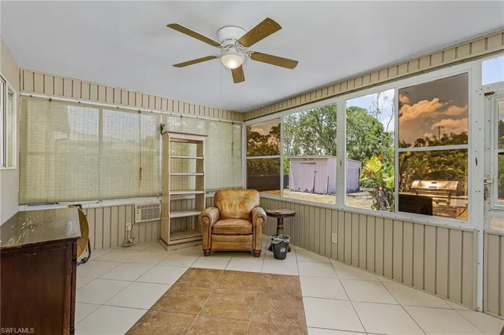 Sunroom featuring ceiling fan