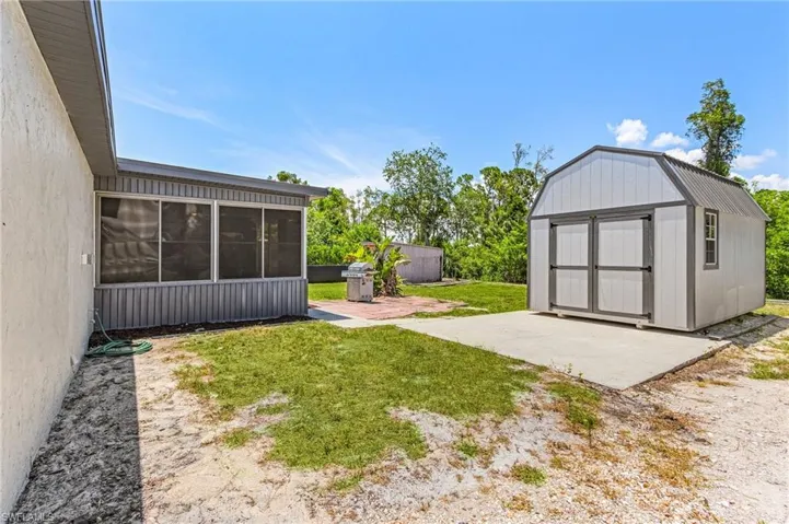 View of yard featuring a patio area and a storage unit